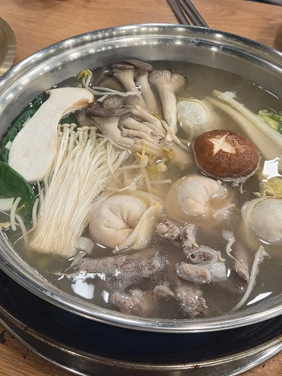 Adding dumplings into the hot pot to cook
