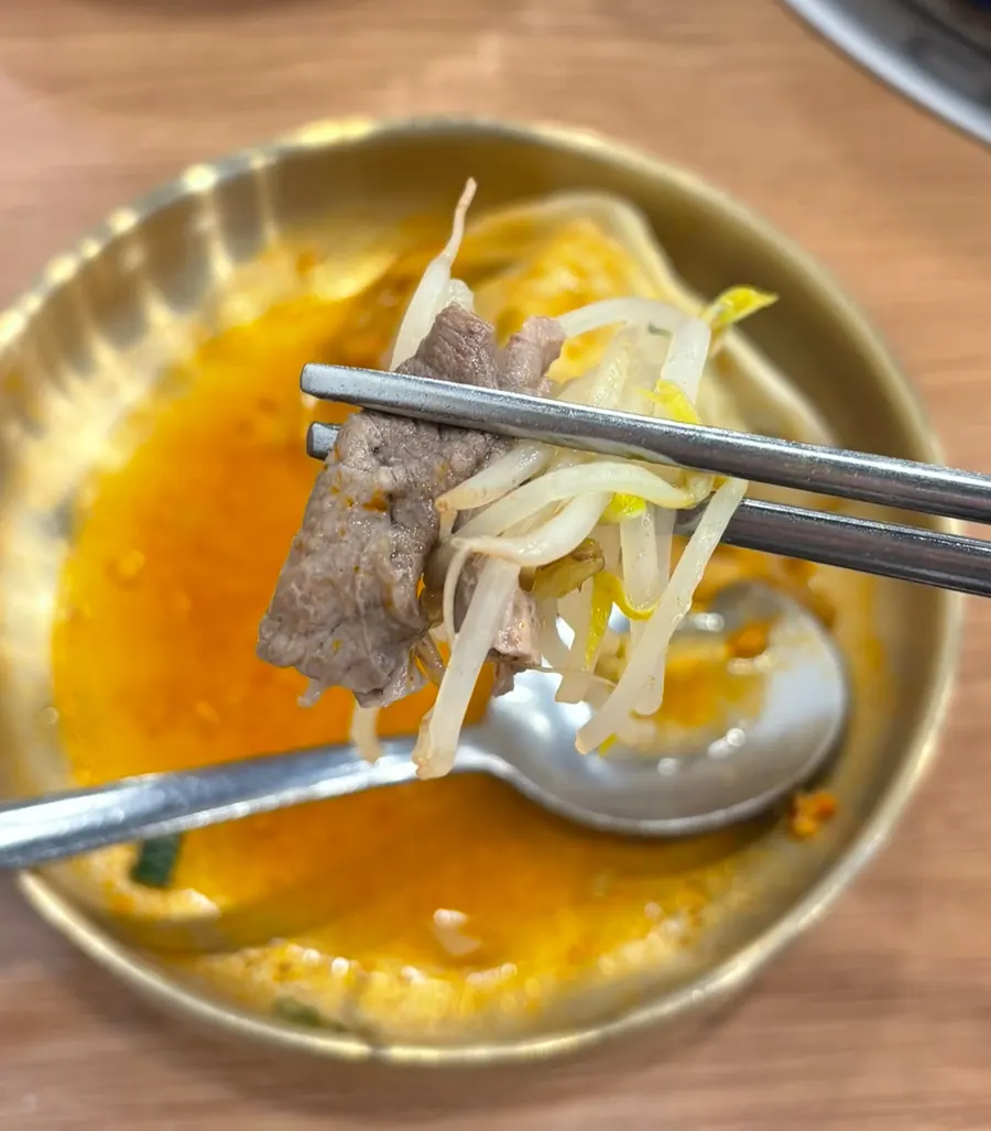 A full spread of split-broth dumpling hot pot