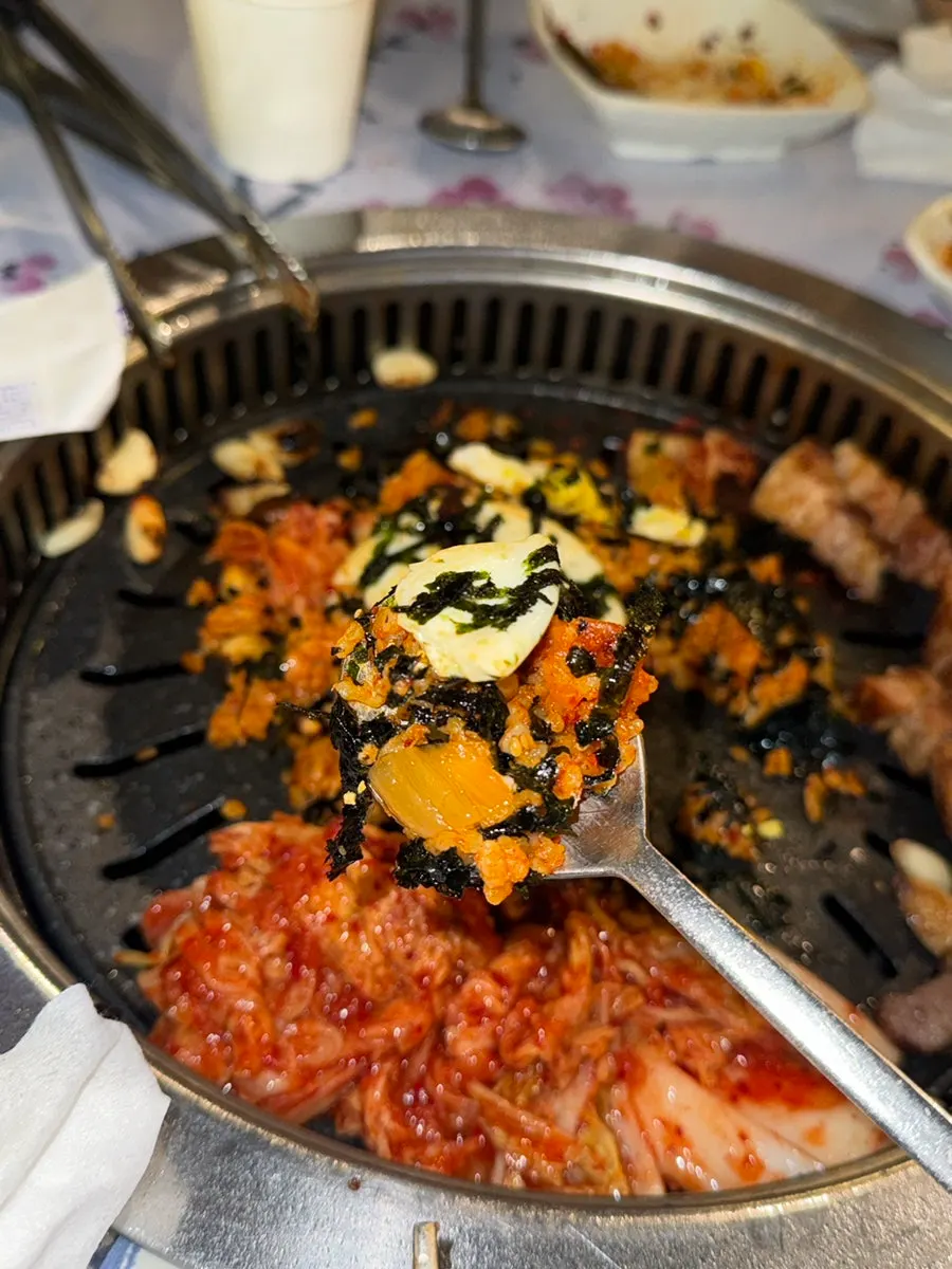 Kimchi fried rice topped with seaweed flakes and a fried egg