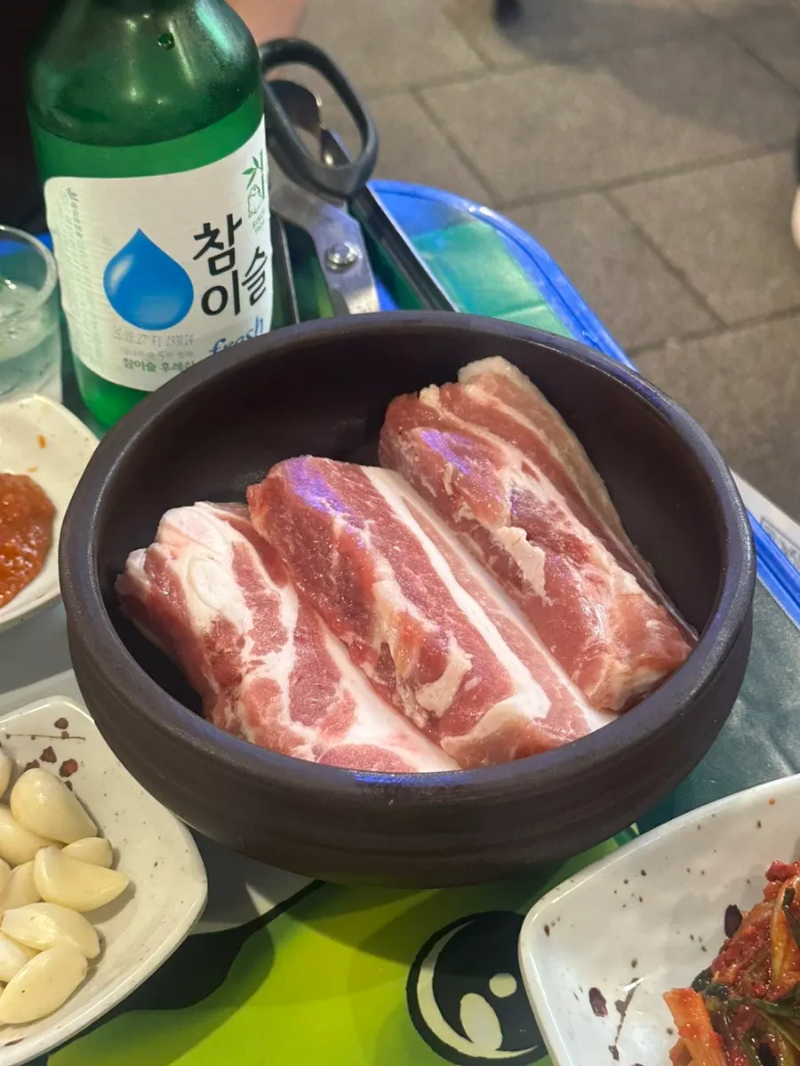 Table setting with thickly sliced aged pork belly