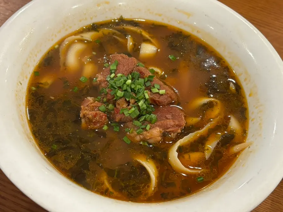 Bowl of beef dosakmyeon placed next to the rice bowl