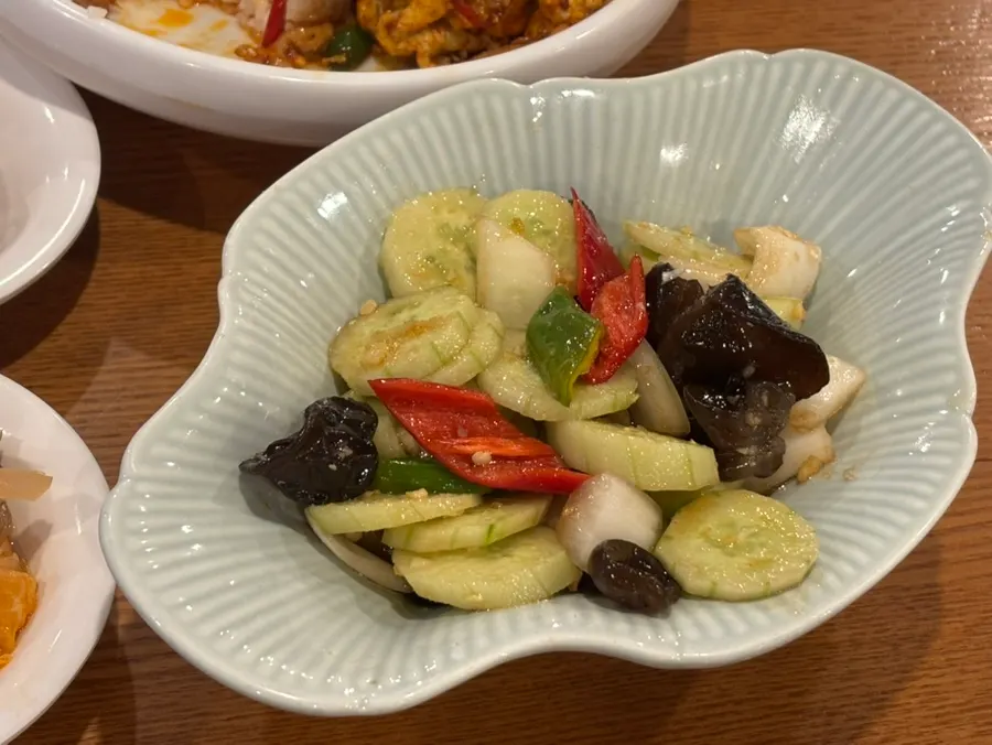 Scooping up noodles from the beef dosakmyeon