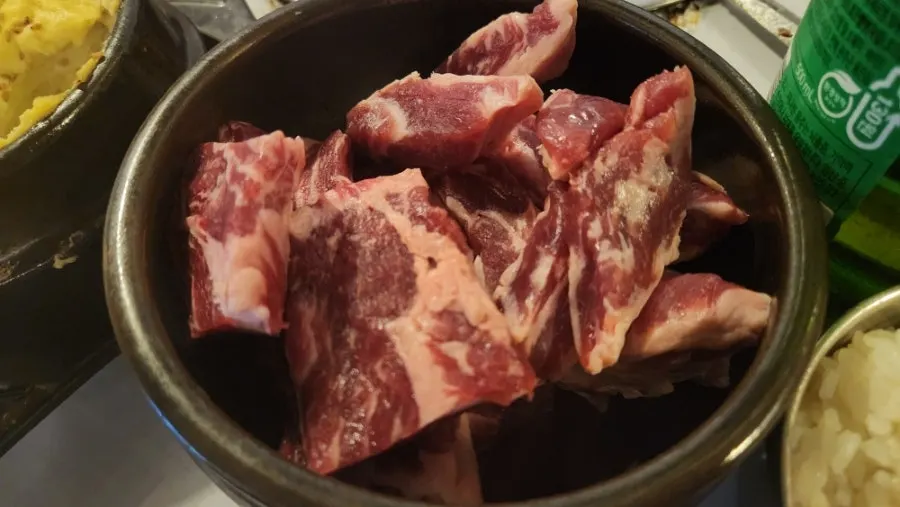 Aged pork belly and pork jowl served in a jar-like bowl