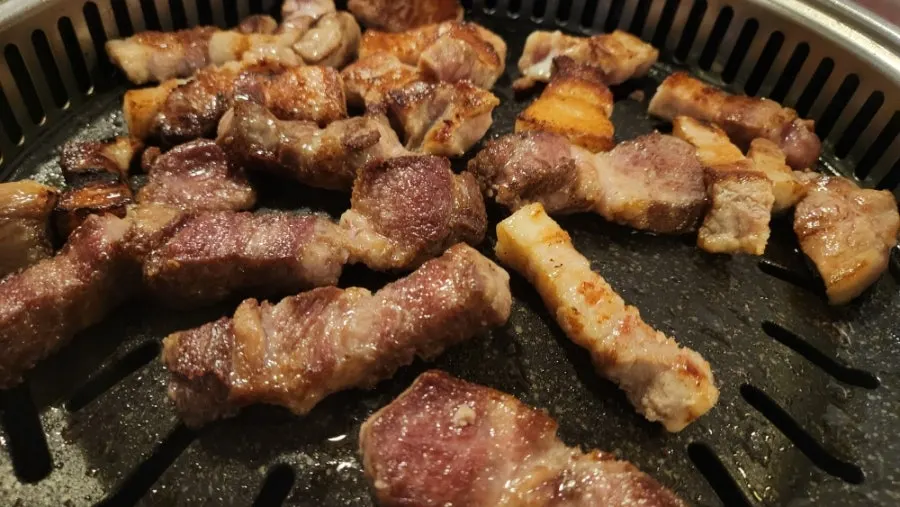 Thick aged pork belly grilling on the hot plate