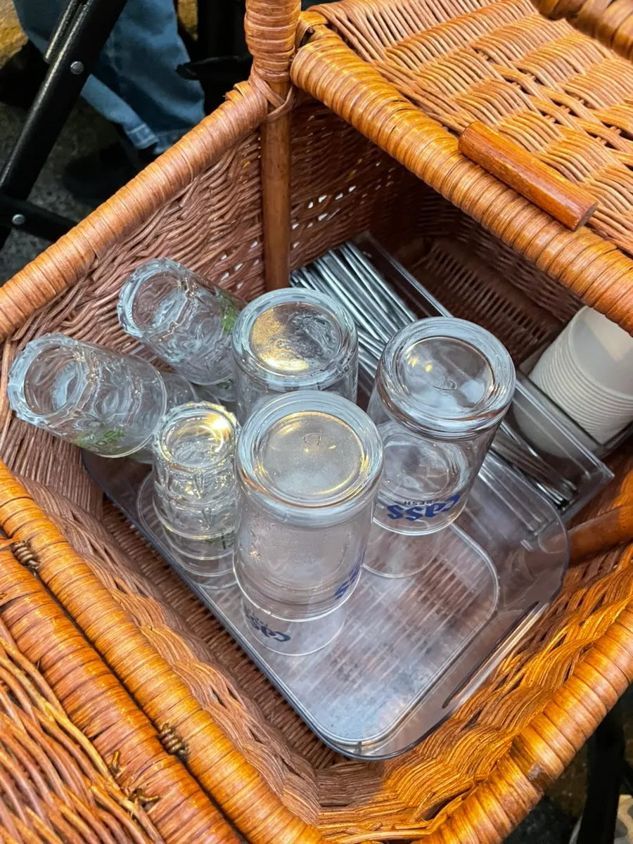 Table basket with utensils and soju glasses, and side dishes set up