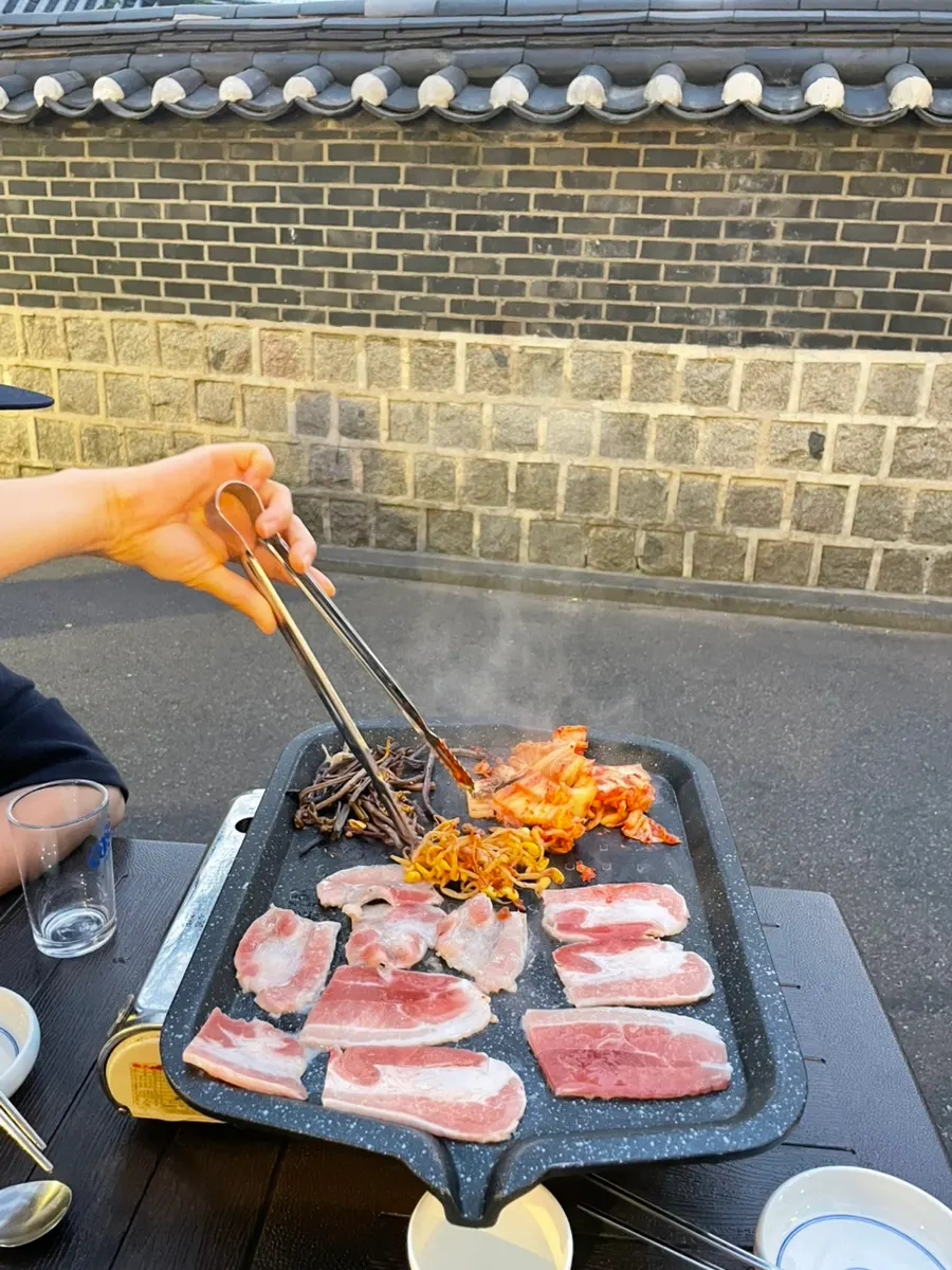 Frozen pork belly cooking on the outdoor table