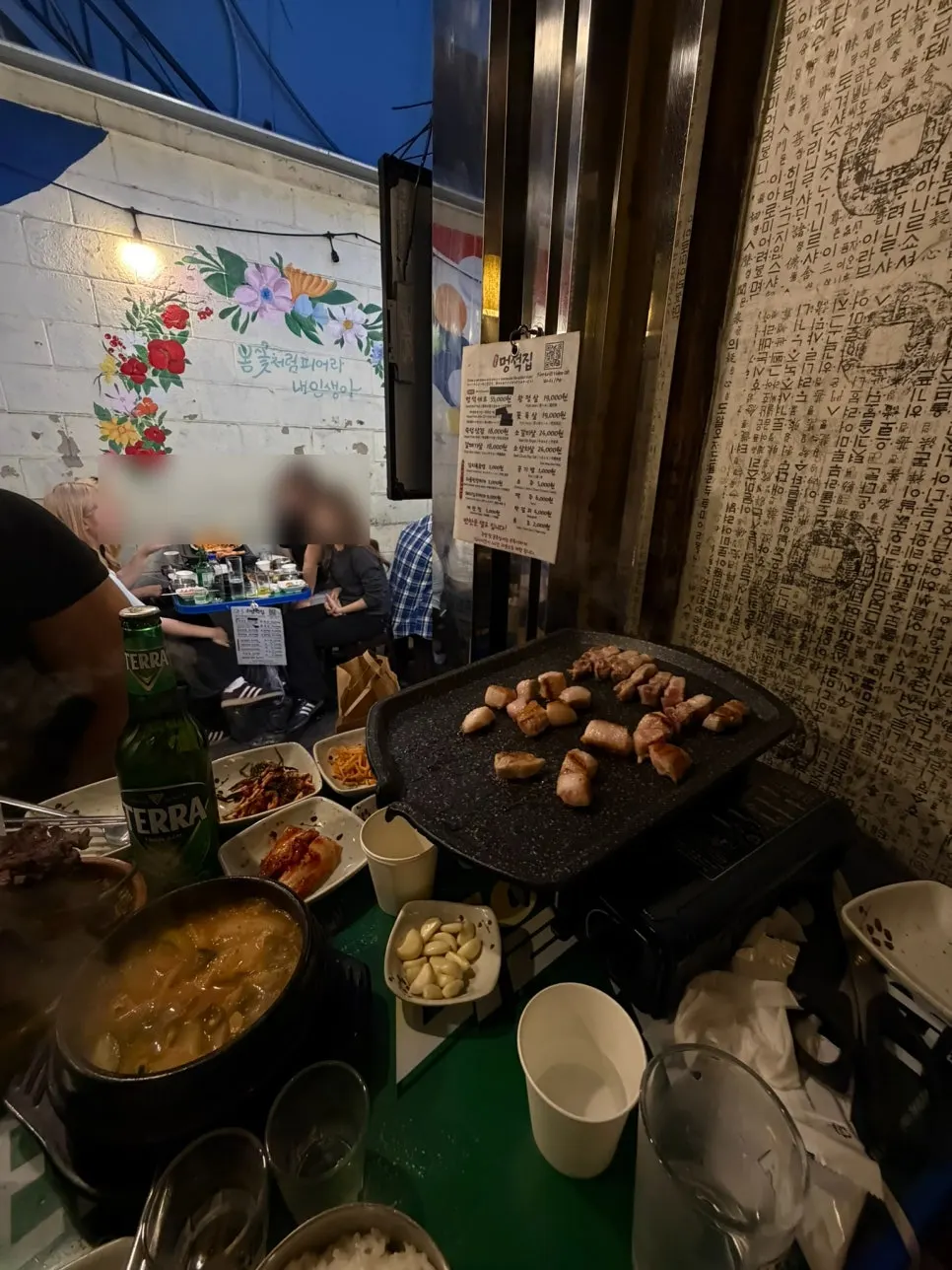 Thick-cut pork belly and pork jowl grilling on the griddle
