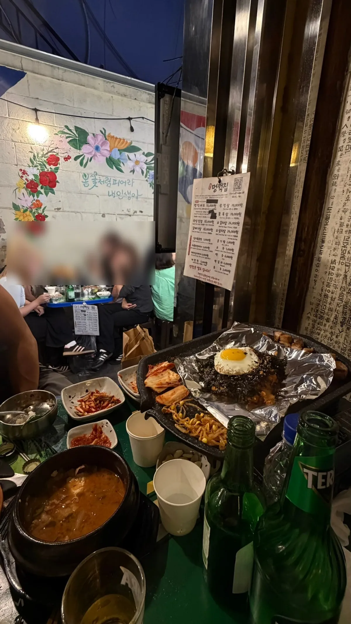 Alley view of Meongseokjip showing its outdoor-alley BBQ atmosphere