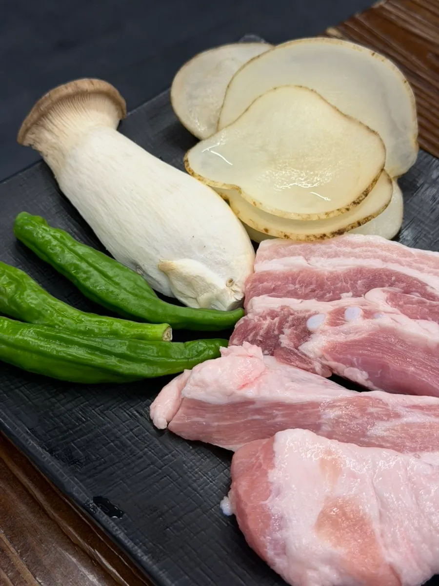 Two-person table setting of samgyeopsal and hangjeongsal
