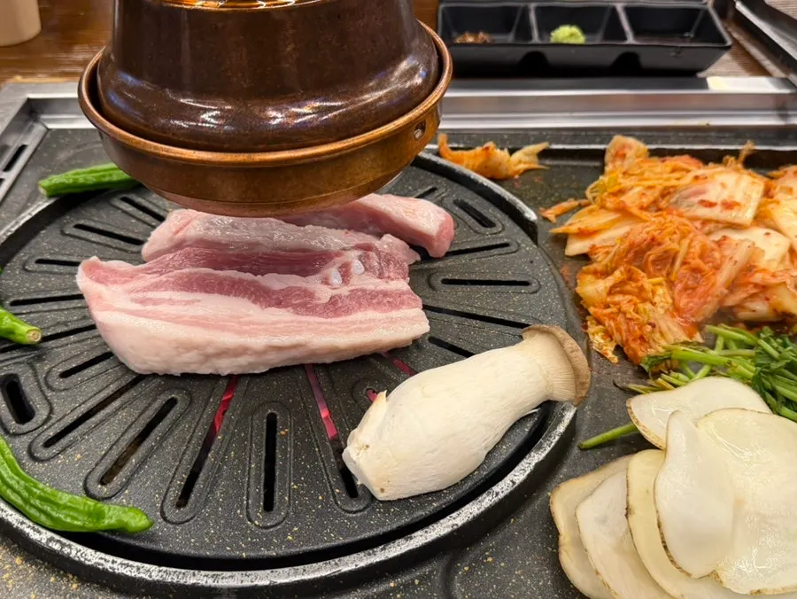 Side vegetables of shishito-style peppers, king oyster mushrooms and sliced potato