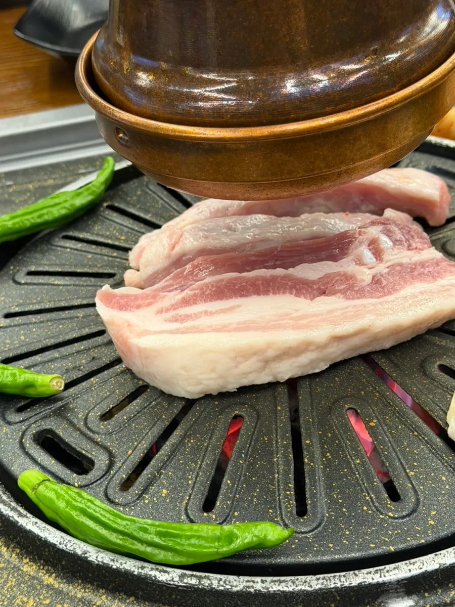 Pork belly and vegetables on the grill
