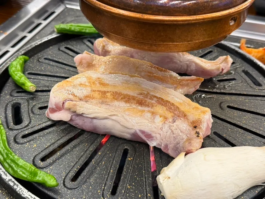 The owner grilling meat on the grill