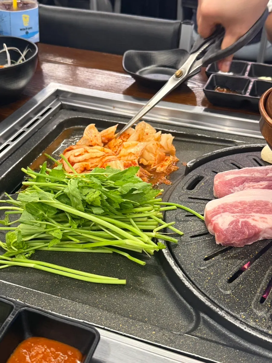Pork belly cooking alongside minari