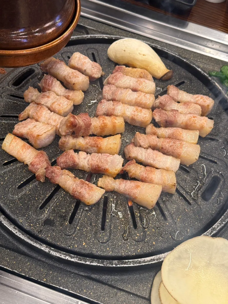 Picking up a piece of pork belly
