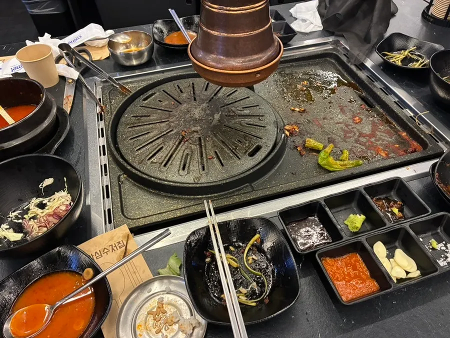 Table setting with kimchi jjigae and rice