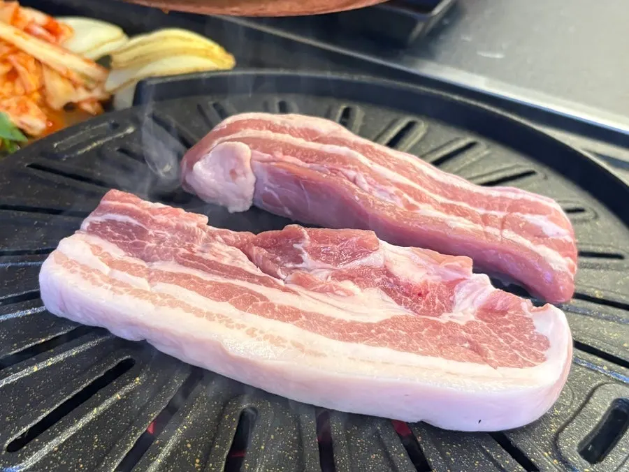 Thin pork belly and black pork belly on the grill
