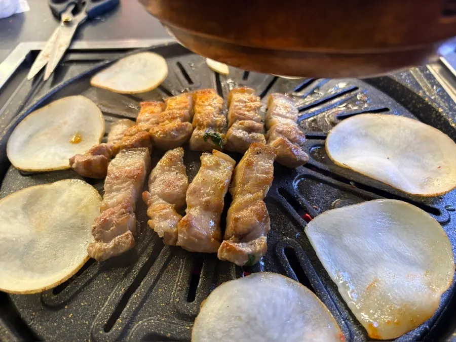 Golden-brown pork belly and potato slices