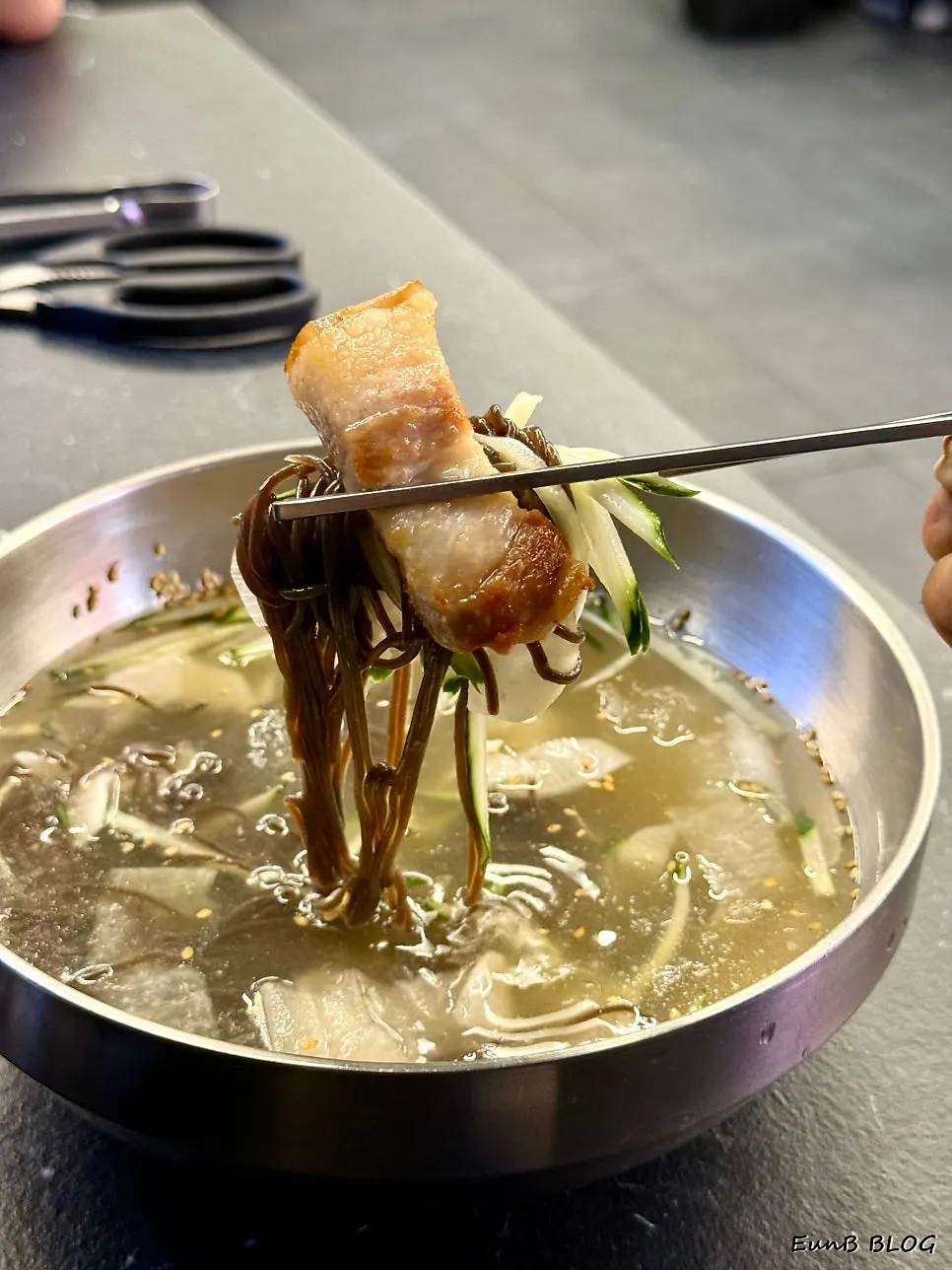 A canned drink served alongside the cold noodles