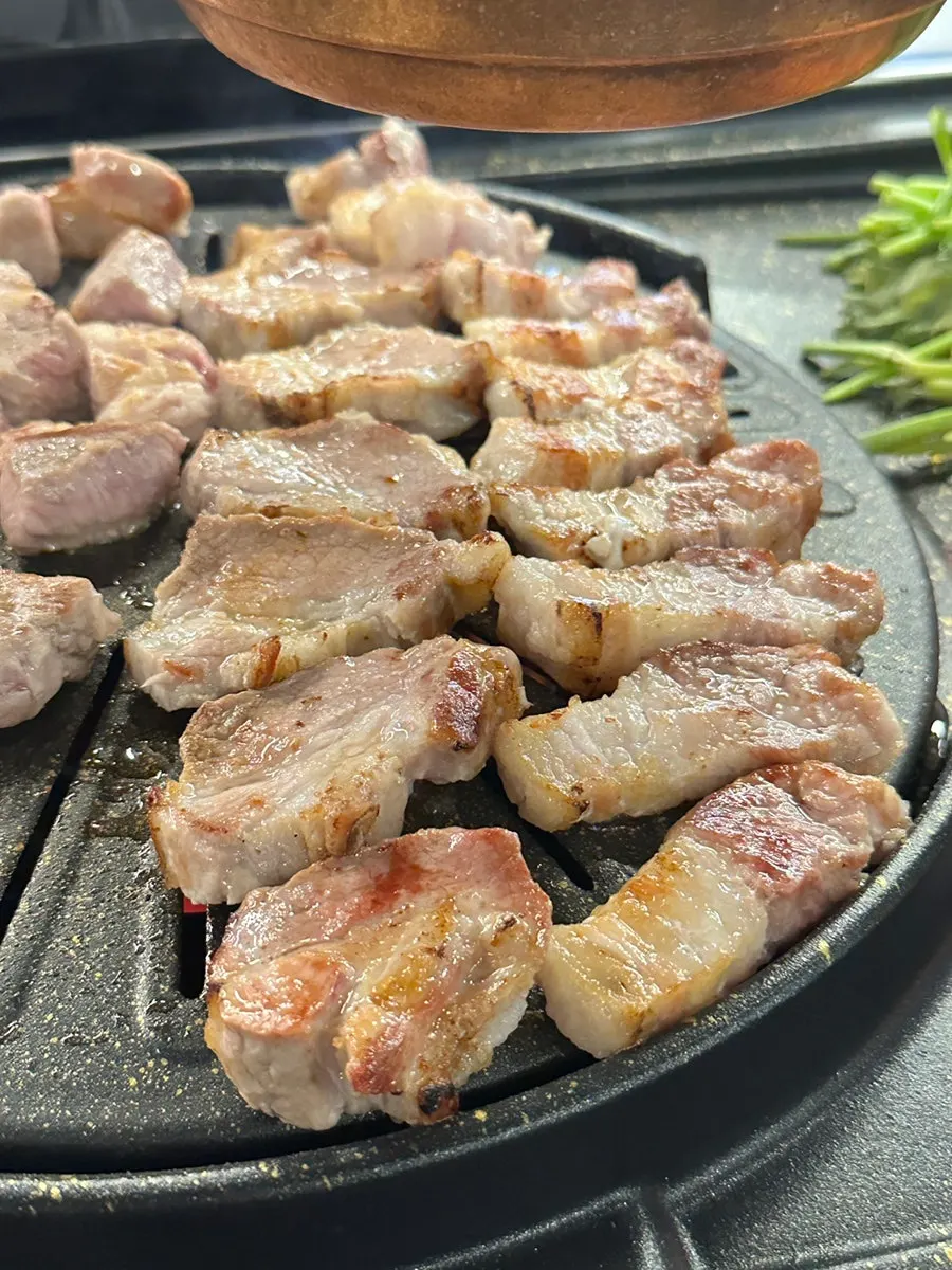 Pork belly cooking on the grill