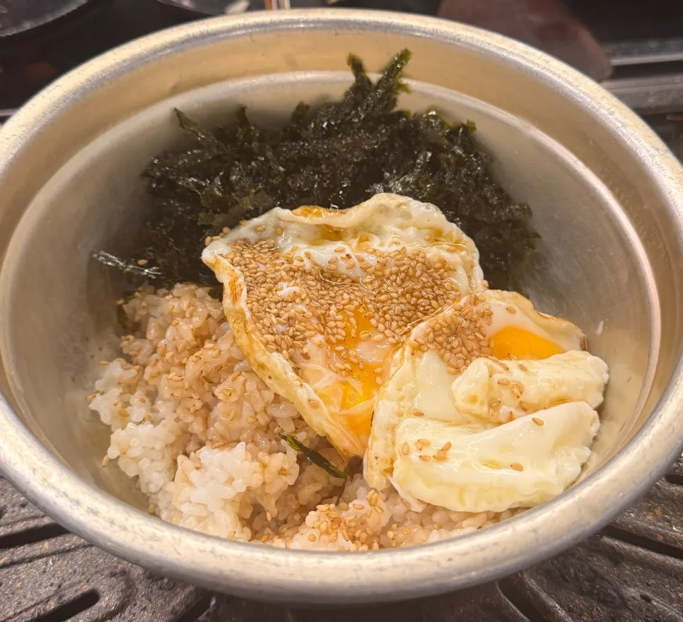 Margarine soy sauce egg rice served in an aluminum pot