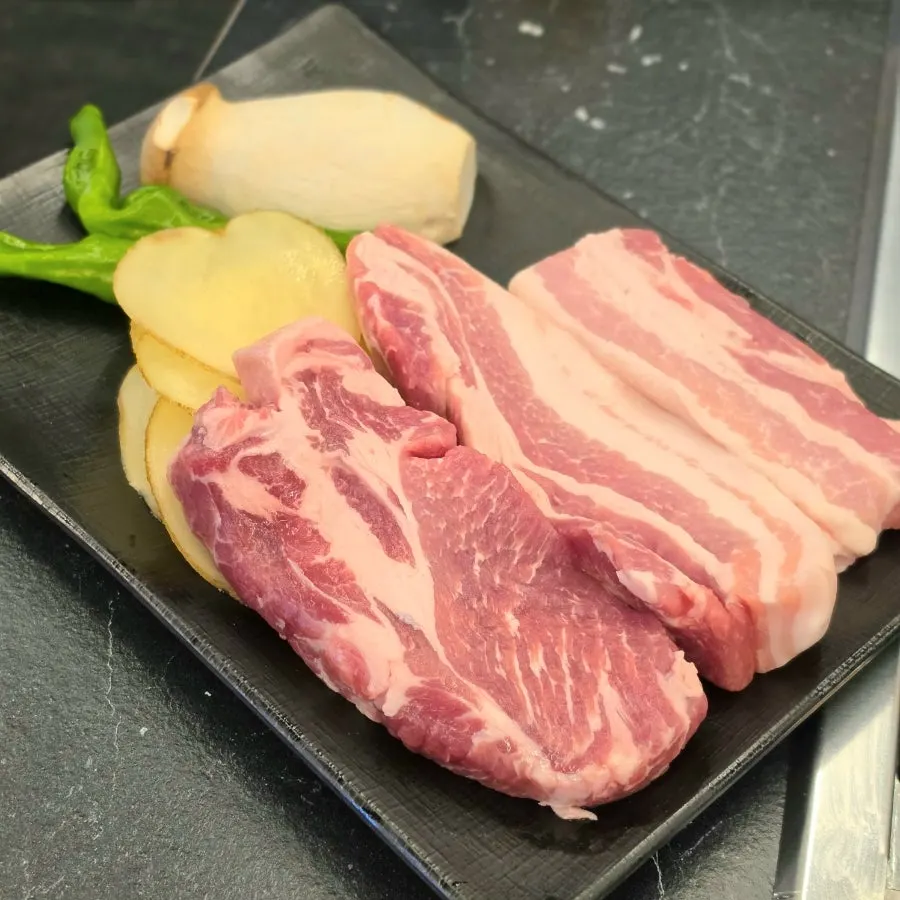 A plate of thick-cut raw pork belly and pork neck
