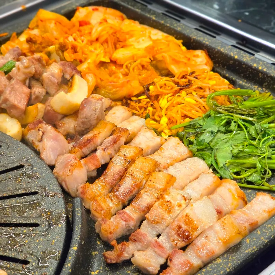 Grilled meat moved to the vegetable side away from direct flame