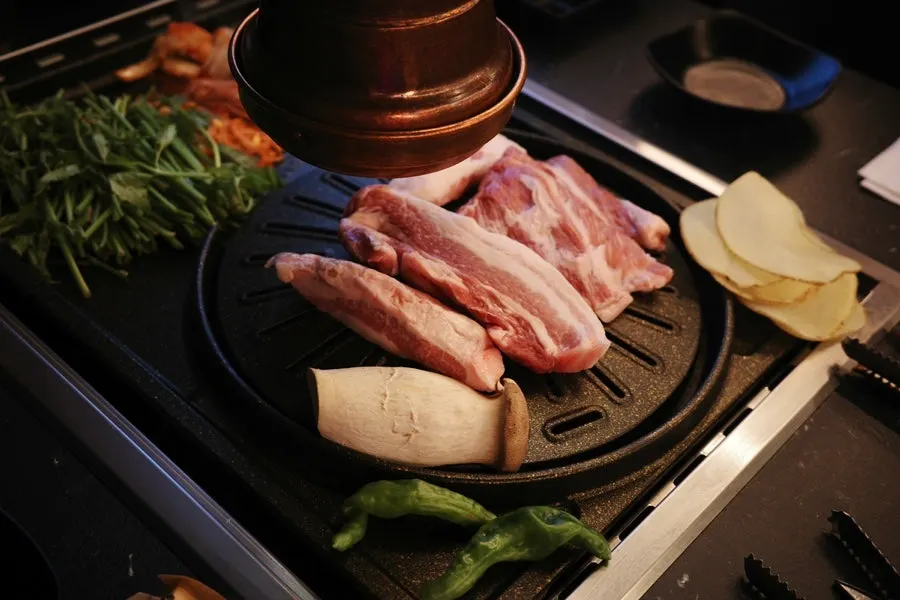 Cham samgyeopsal and black pork ogyeopsal side by side