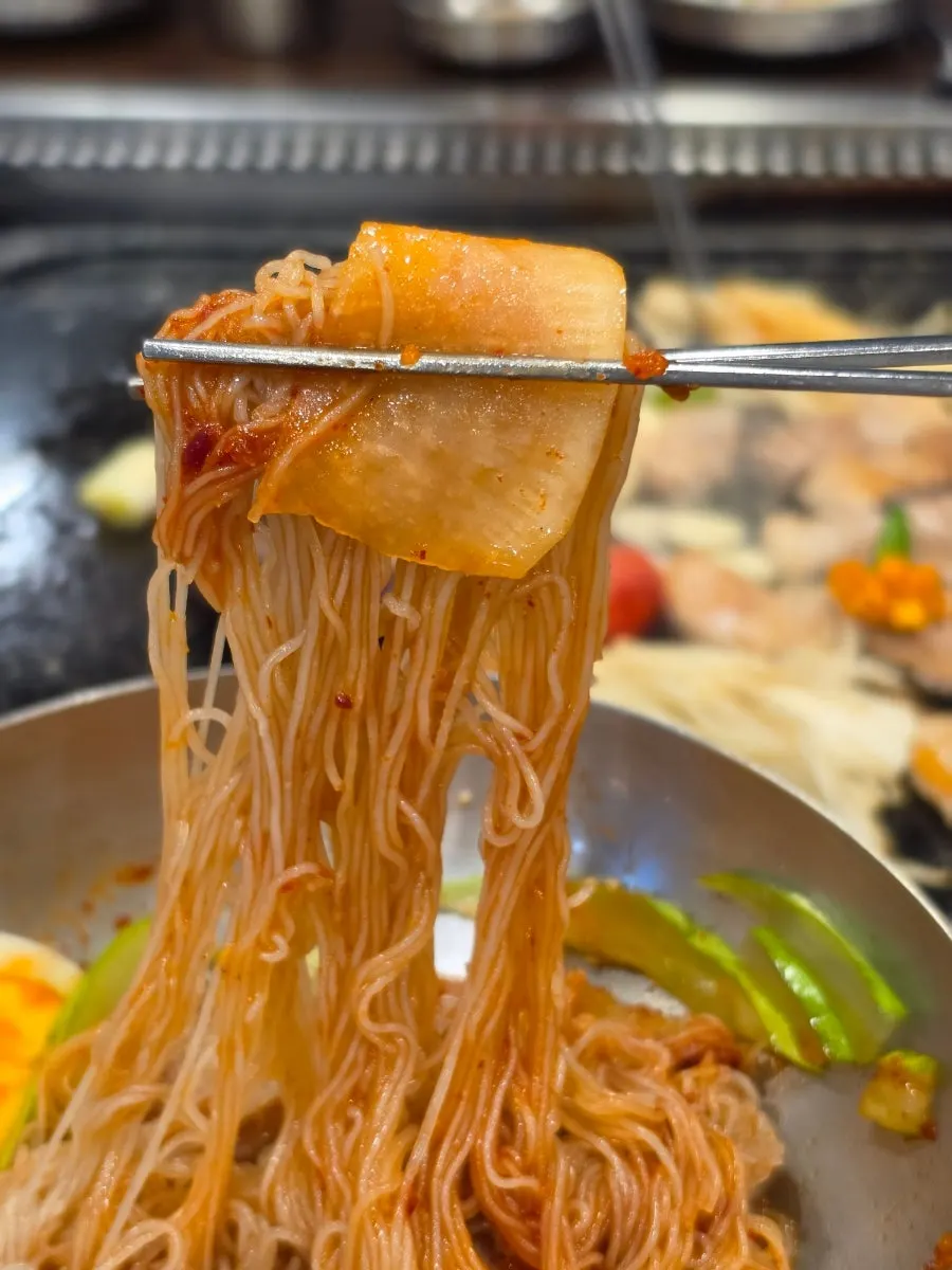 Bibim naengmyeon with pickled radish and cucumber