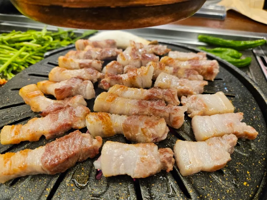 Pork belly grilling on the pan