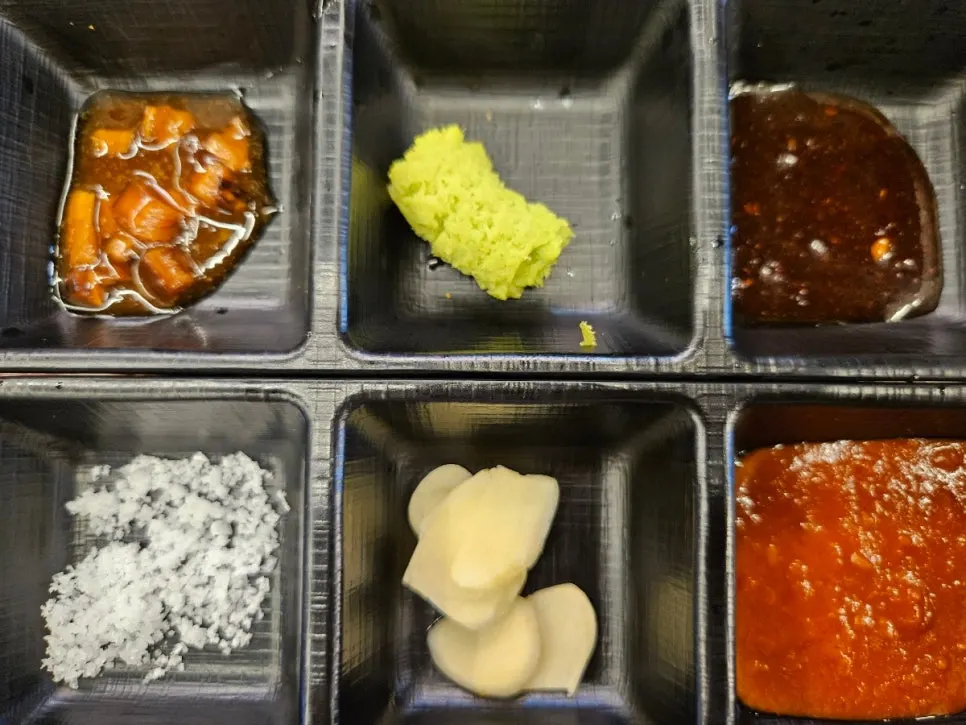 Per-person sauce set with wasabi mushroom sauce, spicy sauce, ssamjang, and salt