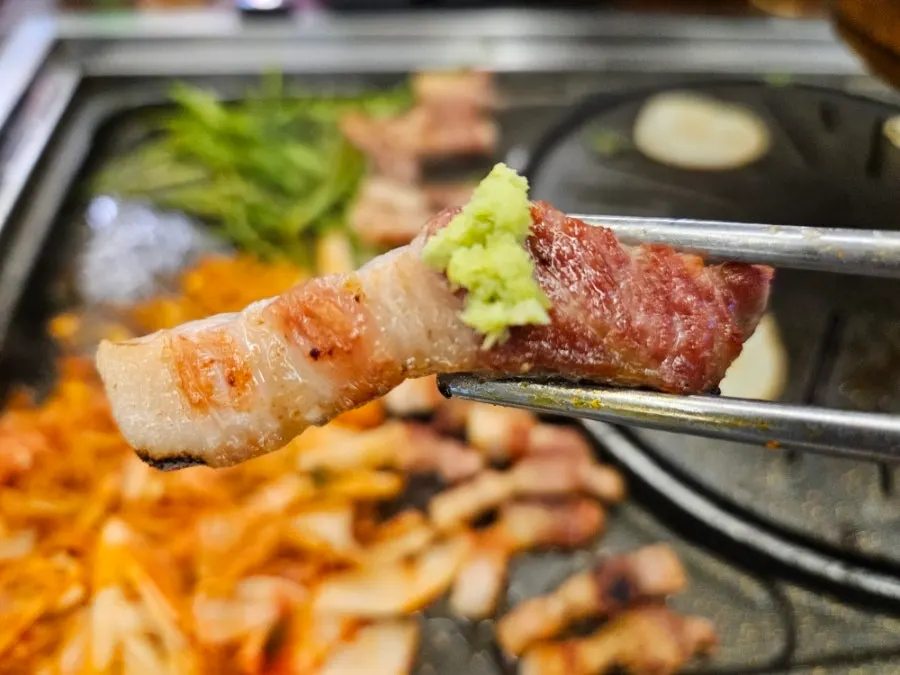 Pork belly dipped in spicy sauce