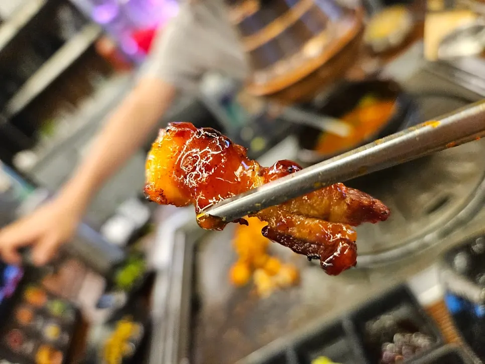 A table spread of pork belly with various sauces
