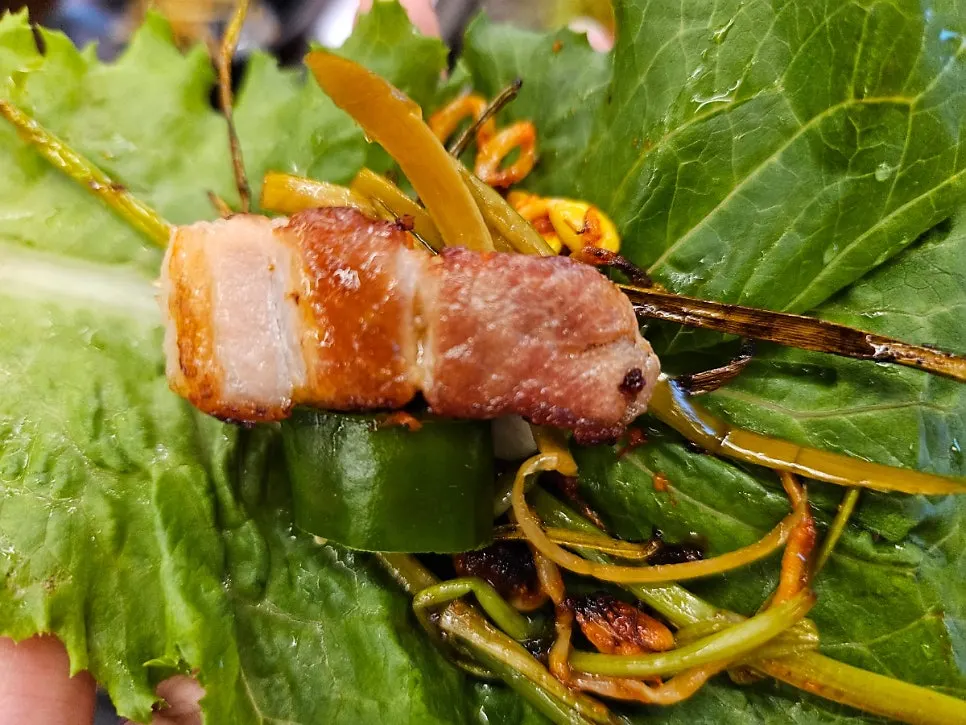 A potato wrap topped with pickled garlic scapes