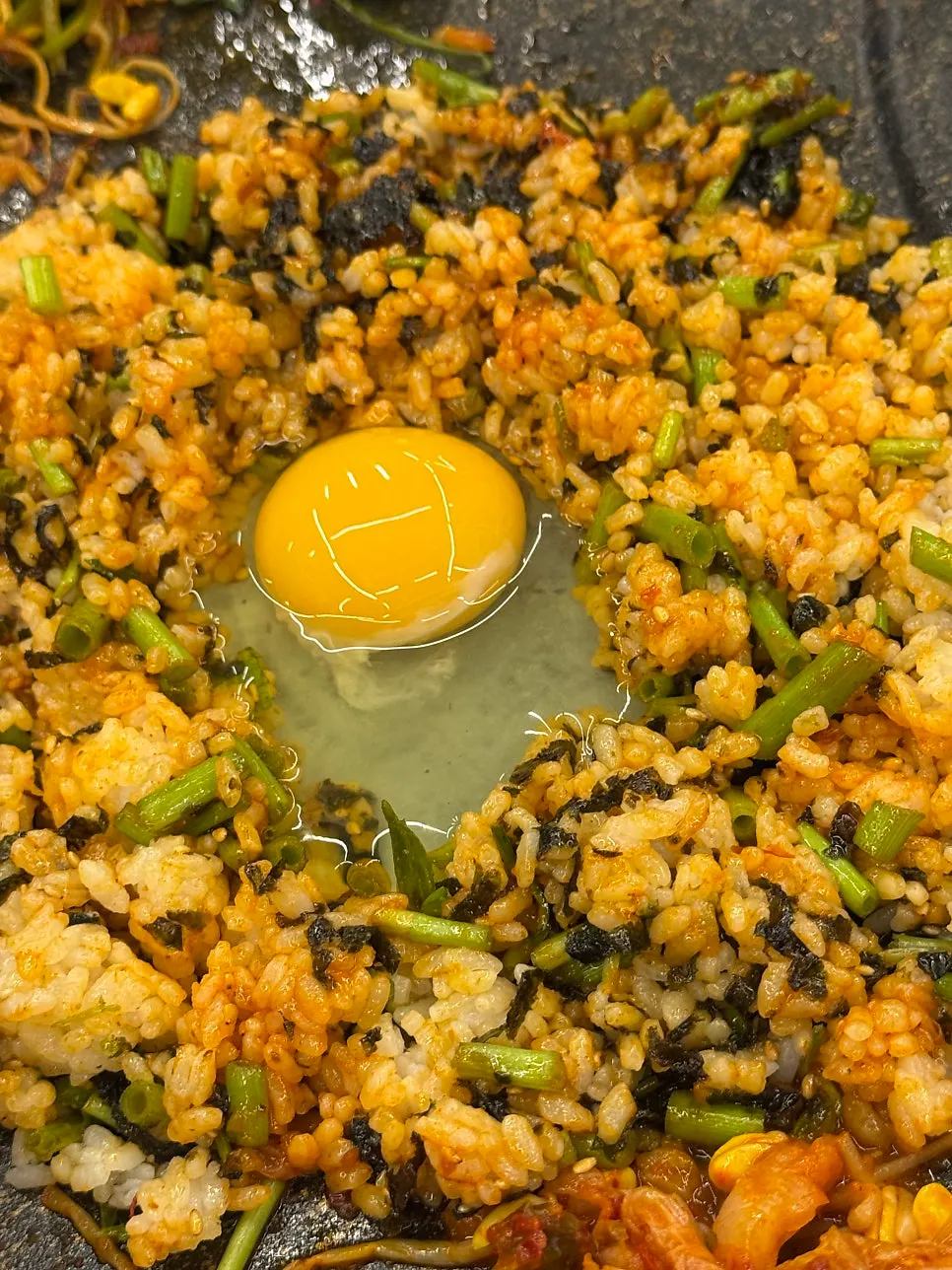 Finishing fried rice topped with egg