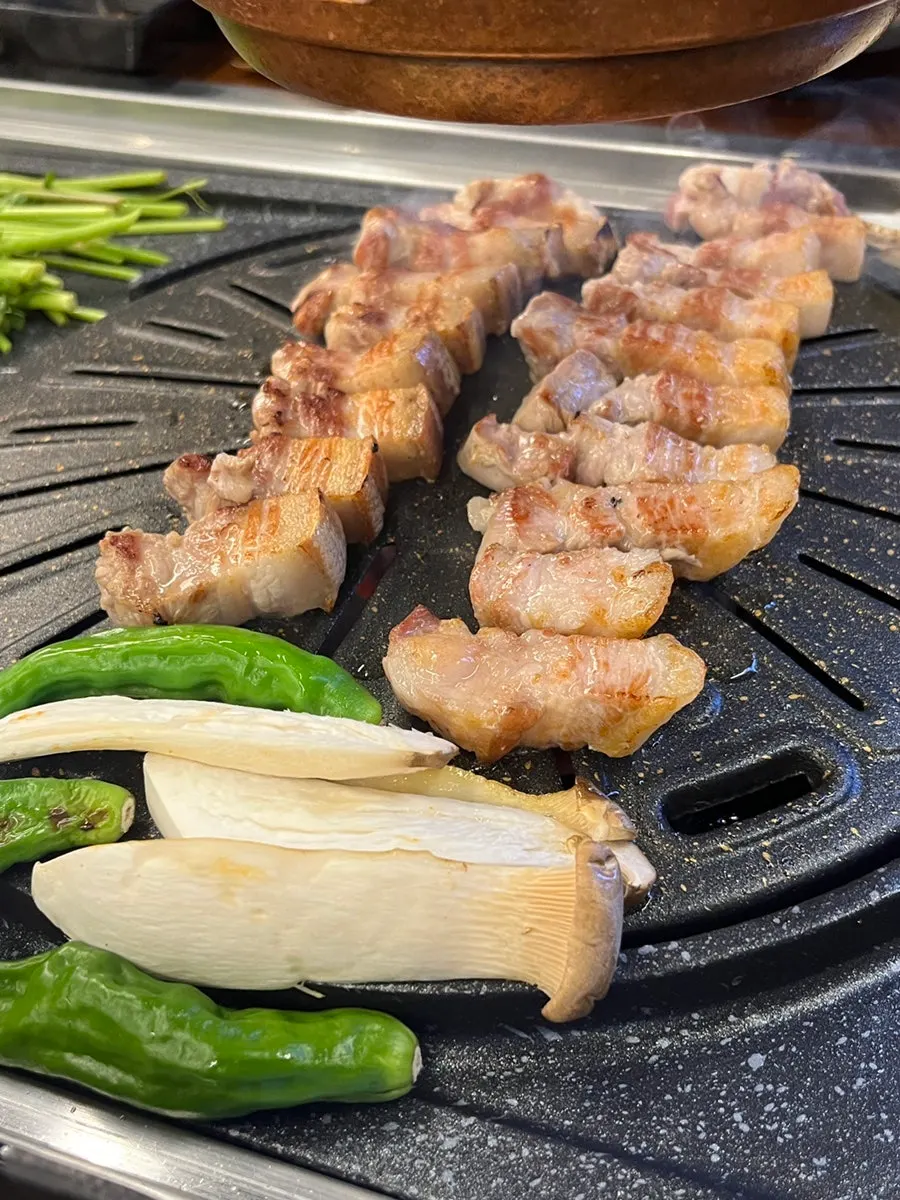 Kimchi and minari grilling beside the meat