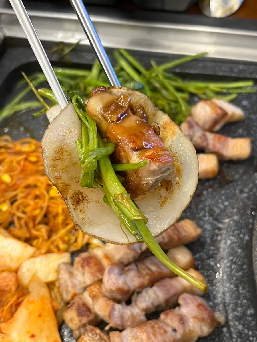 Grilled pork belly placed on a potato wrap