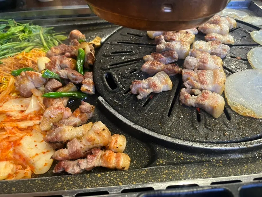 Well-grilled pork belly and pork neck on the grill
