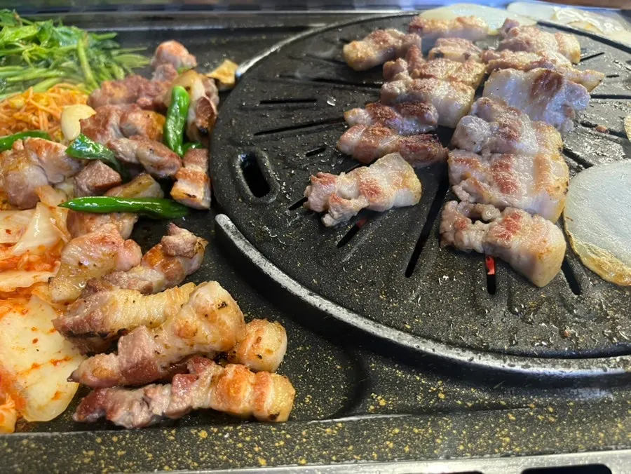 Table with grilled meat and side dishes