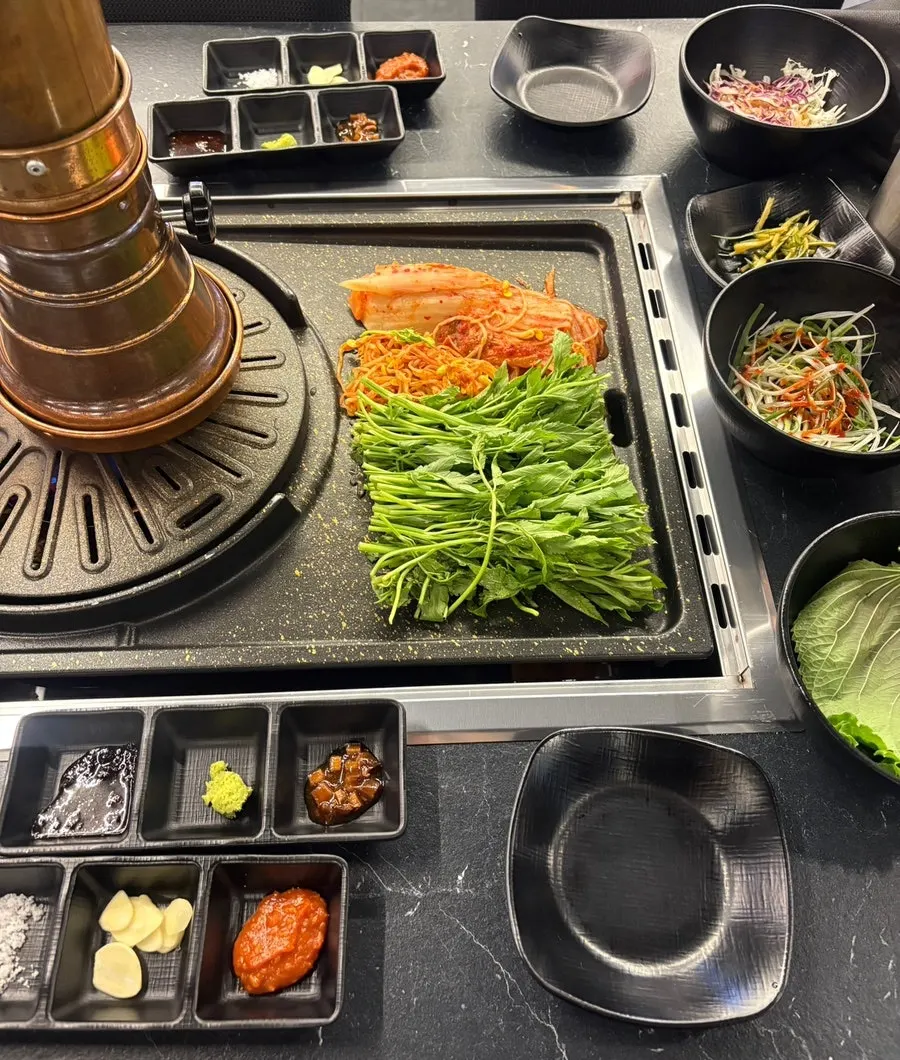 Table set with lettuce wraps and sauces alongside basic side dishes