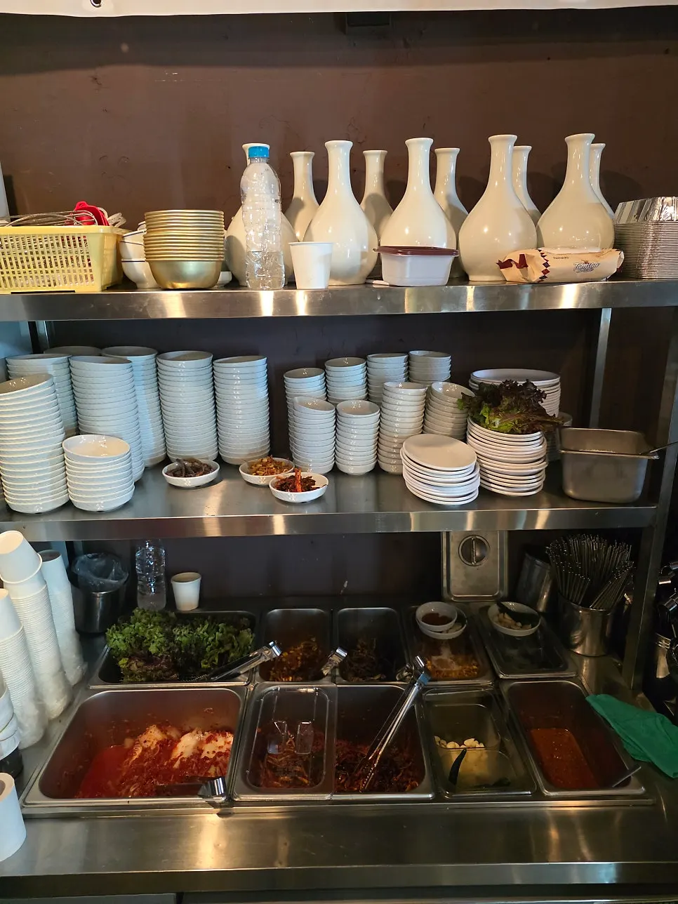 Tray of banchan set up at the outdoor tent table