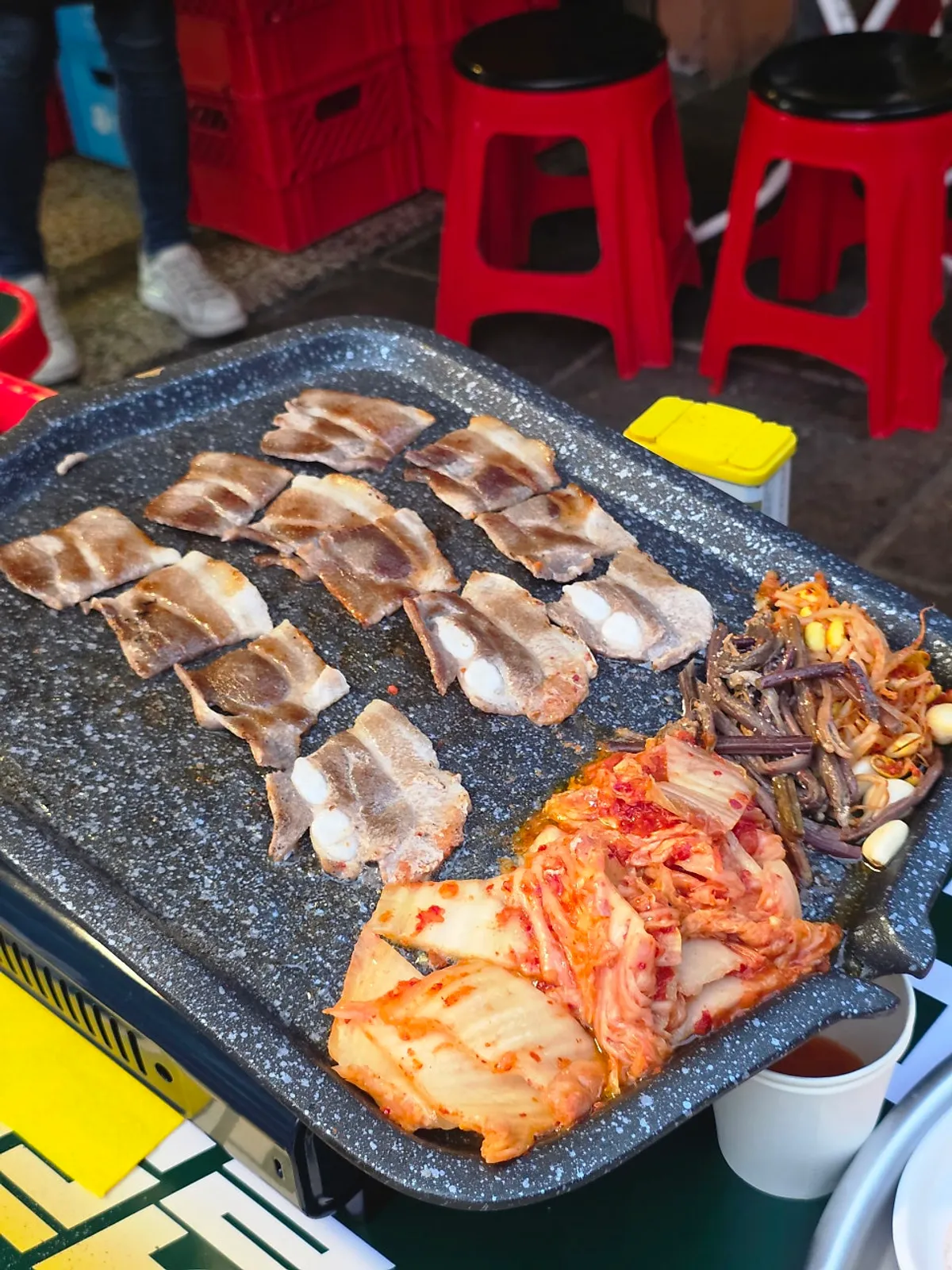 Kimchi and pork belly grilled together in meat fat