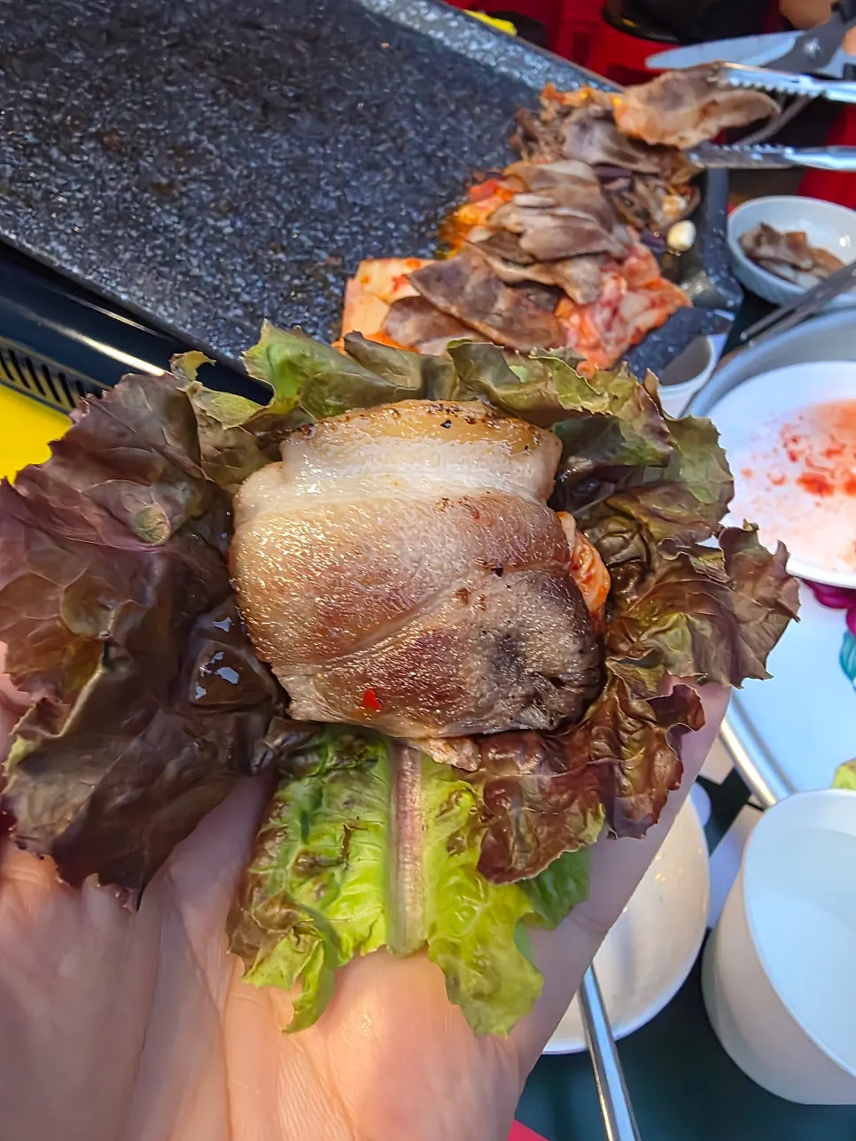 Soju alongside a piece of grilled pork belly