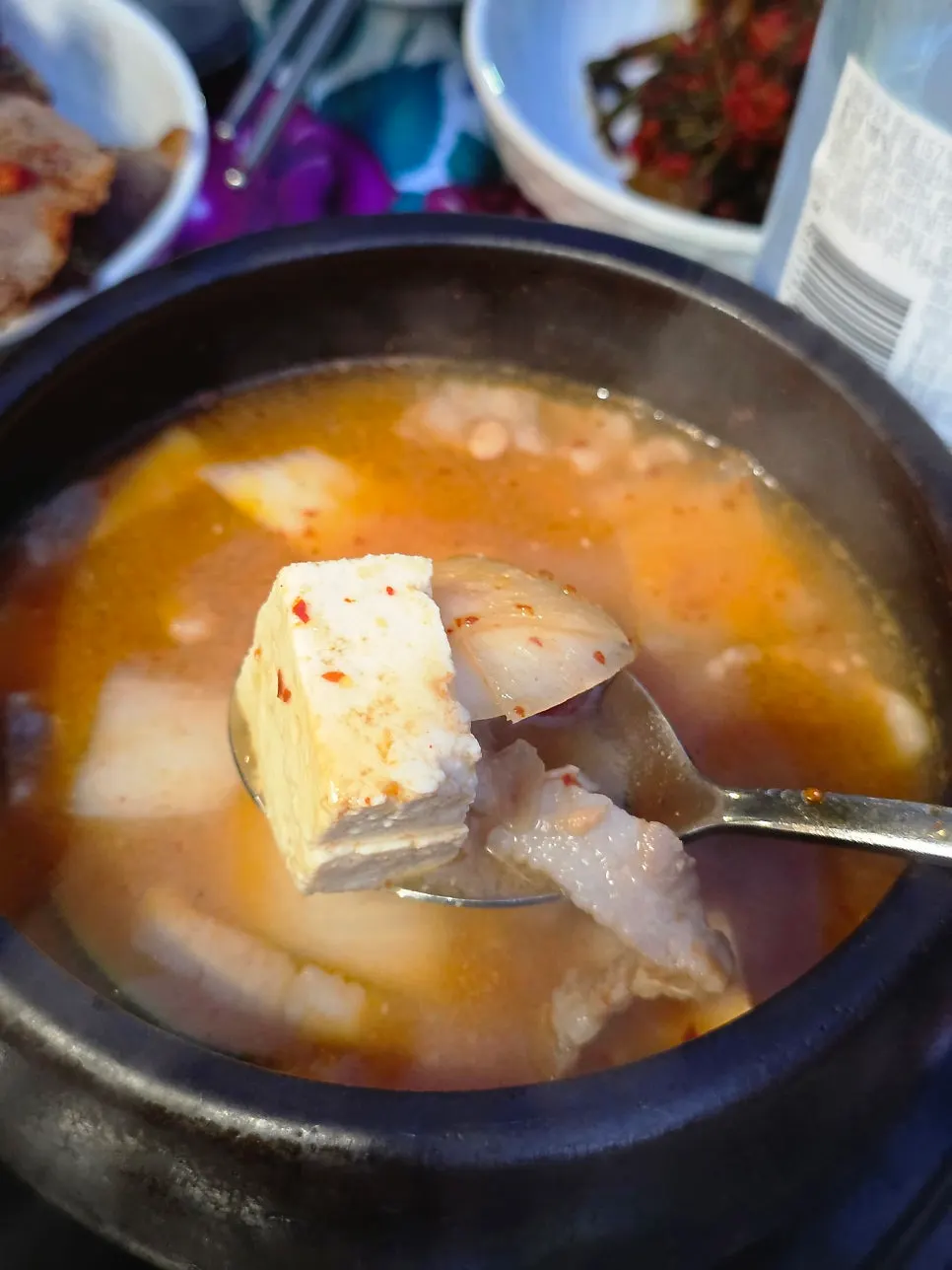 Doenjang jjigae with pieces of pork belly inside