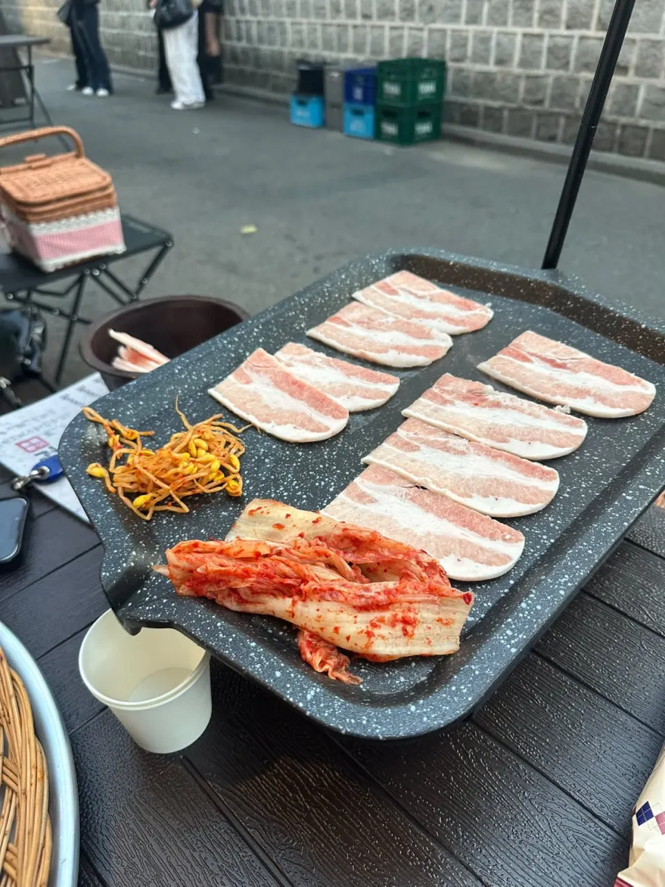 Kimchi and bean sprouts grilling together in the pork belly fat