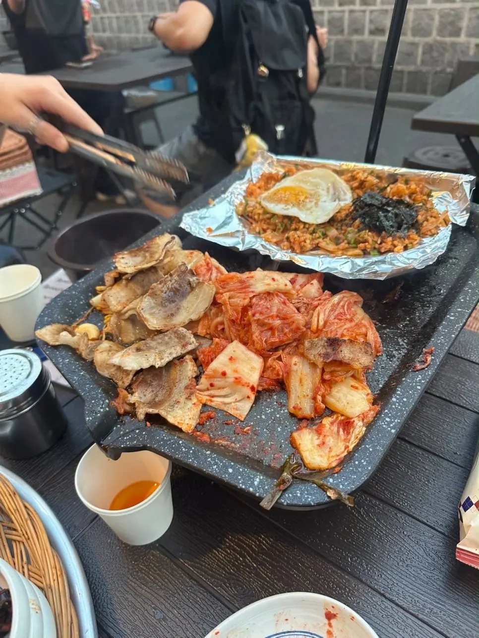 A spoonful of kimchi fried rice being lifted up
