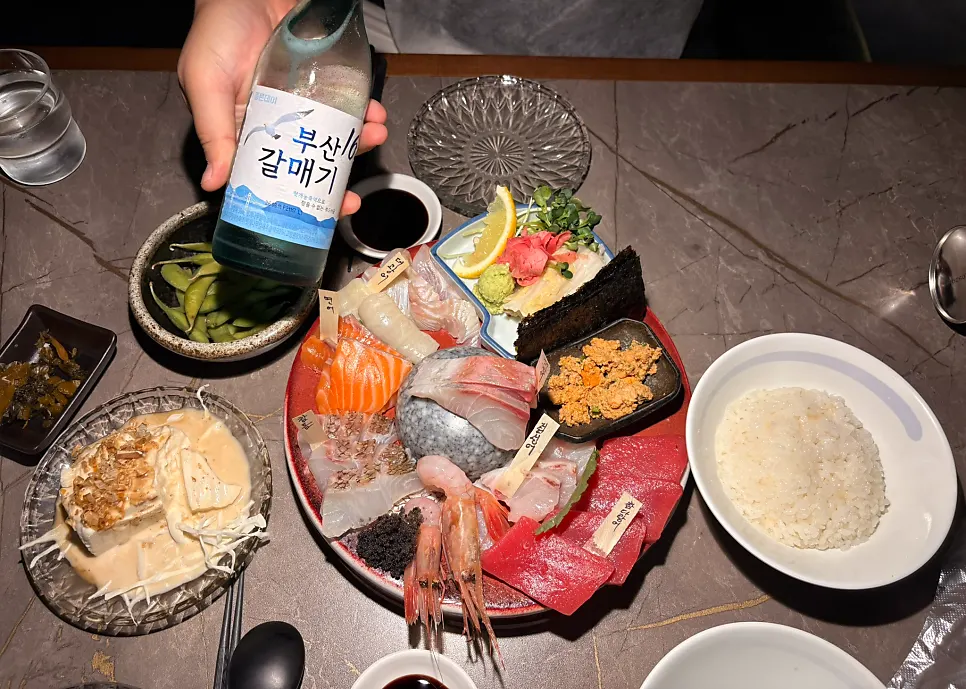 Table spread with aged sashimi and side dishes