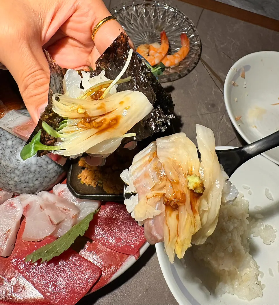 Plate of sashimi with both of us busy eating