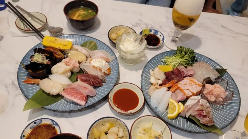 Assorted sashimi and sushi served on plates