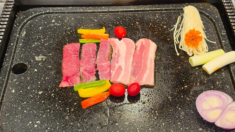Plate of wagyu flap meat and fresh pork belly