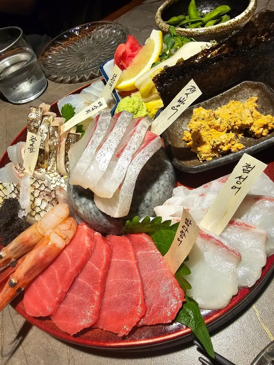 Plate of aged sashimi with fish species name tags